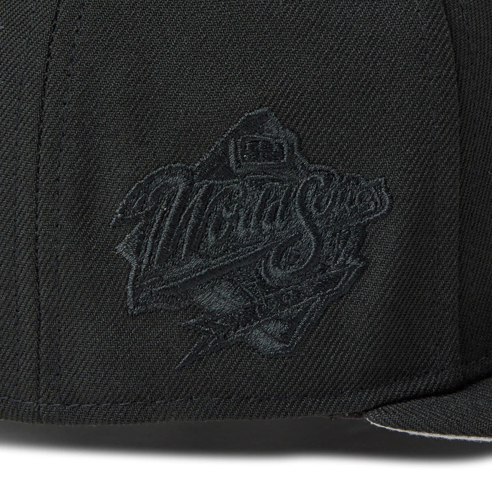 San Diego Padres MLB Black New Era 59FIFTY Fitted Cap, side view showing black embroidered World Series logo on the black structured crown, with detailed stitching throughout the panels.