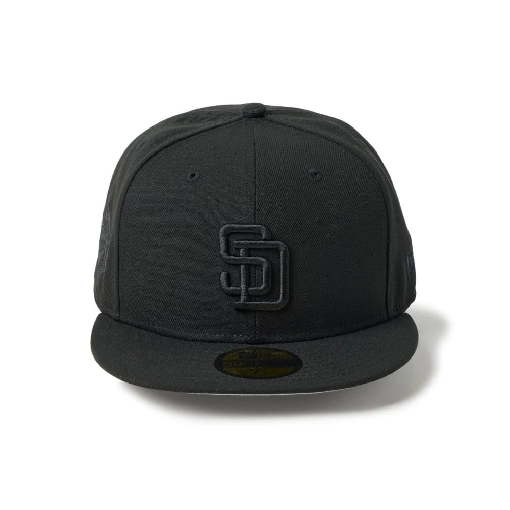 San Diego Padres MLB Black New Era 59FIFTY Fitted Cap, front view with raised black SD logo embroidered on the front panel, featuring a black flat visor and gold 59FIFTY size sticker on top of the visor.