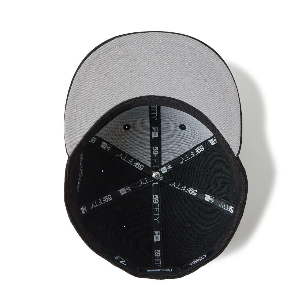 San Diego Padres MLB Black New Era 59FIFTY Fitted Cap, inside view showing the black taping with 59FIFTY branding and a grey undervisor, alongside a white sweatband encircling the interior.