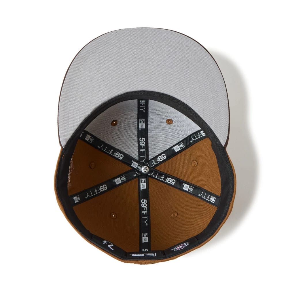 Houston Astros MLB Brown New Era 59FIFTY Fitted Cap, inside view showing grey undervisor, black taping with white 59FIFTY branding, and brown sweatband with eyelets, highlighting the detailed internal structure of the cap.