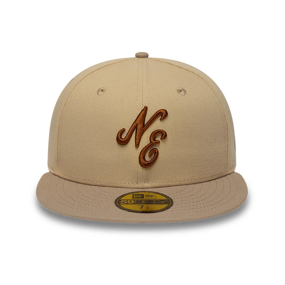 New Era Mocha Mousse Light Beige 59FIFTY Fitted Cap, front view showing the raised brown embroidered NE logo on the front panels, complete with a matching light beige visor and a gold 59FIFTY size sticker centred on the visor.