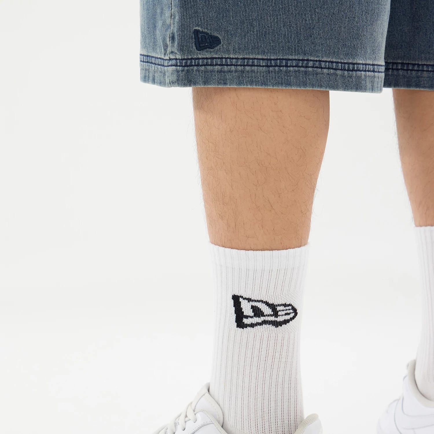 The model is wearing this New Era Washed Bermuda Shorts in blue. 4