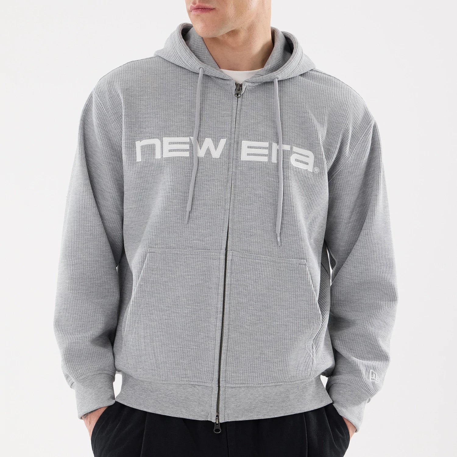 The model is wearing this New Era Waffle Full Zip Hoodie in grey. 3