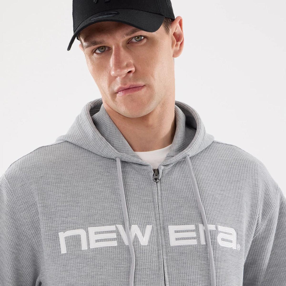 The model is wearing this New Era Waffle Full Zip Hoodie in grey. 4
