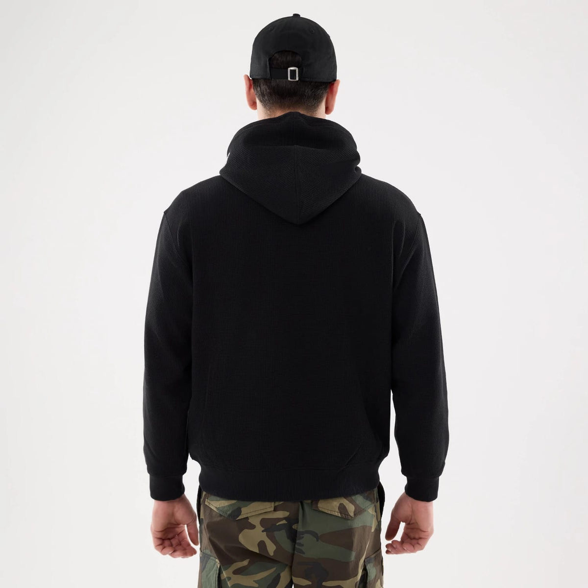 The model is wearing this New Era Waffle Full Zip Hoodie in black. 2