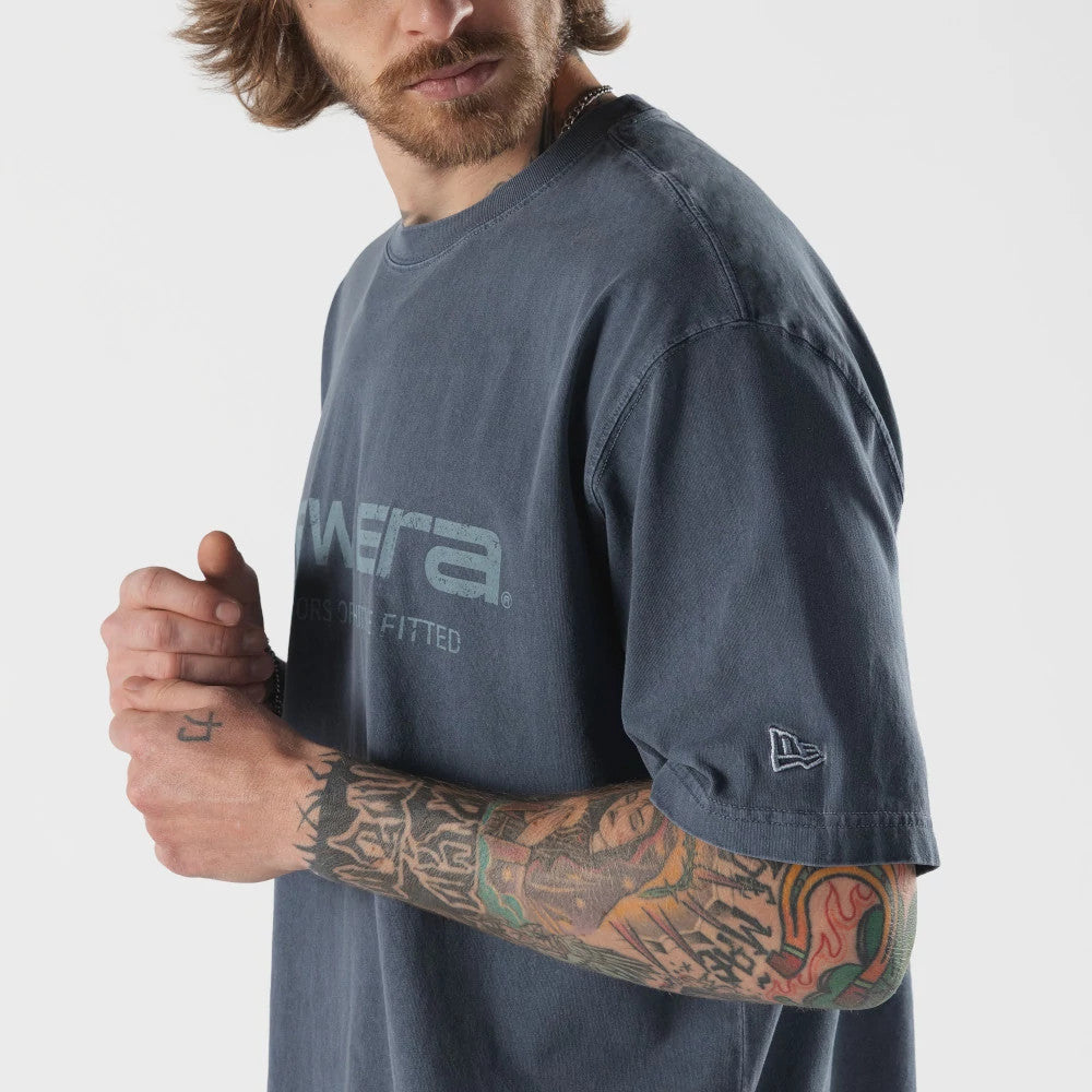 The model is wearing this New Era Originators T-Shirt in navy. 4