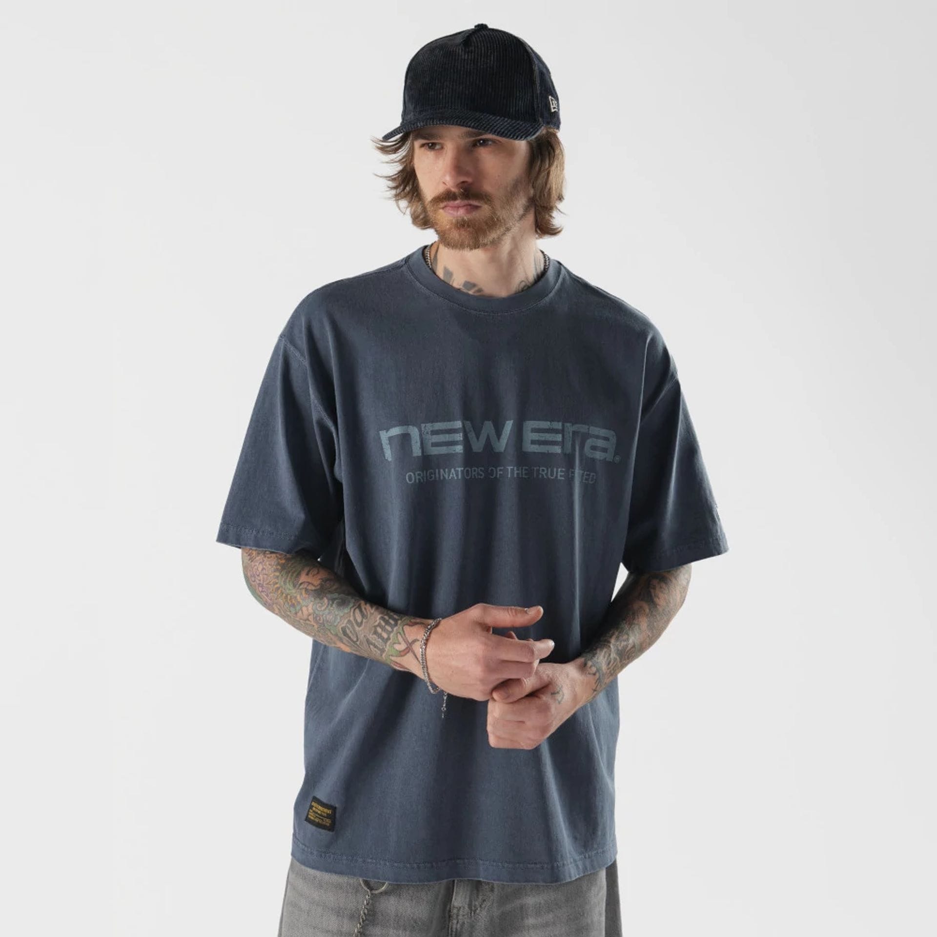 The model is wearing this New Era Originators T-Shirt in navy. 1