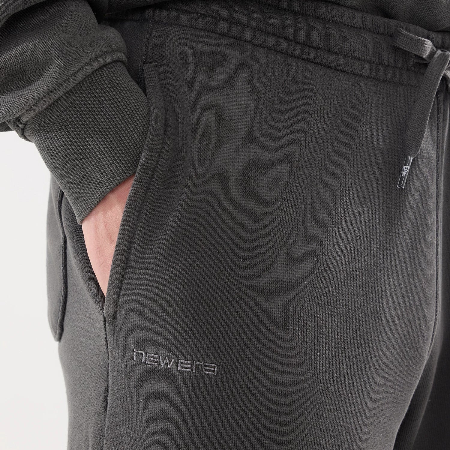 The model is wearing this New Era Originators Straight Leg Joggers in black. 3