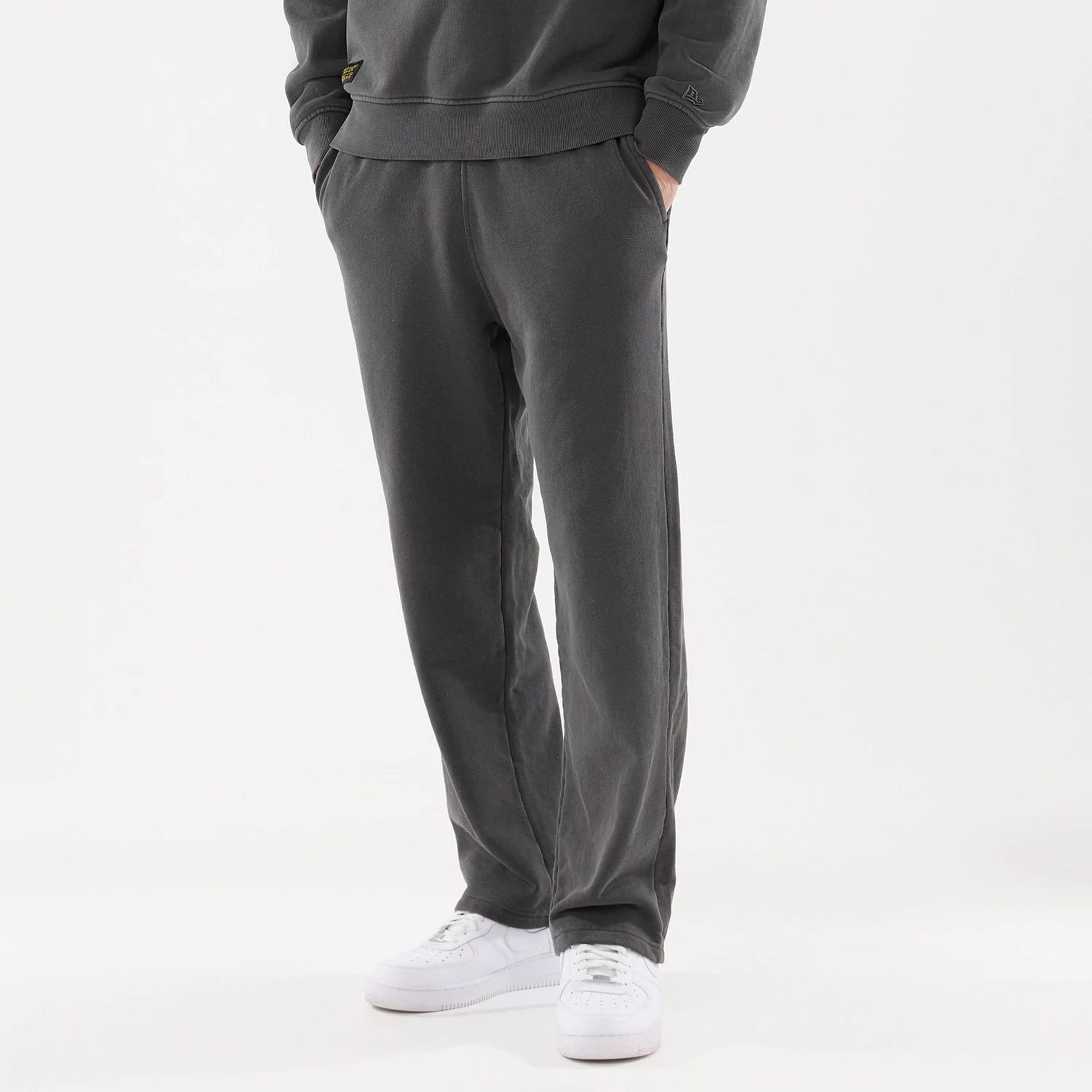 The model is wearing this New Era Originators Straight Leg Joggers in black. 1