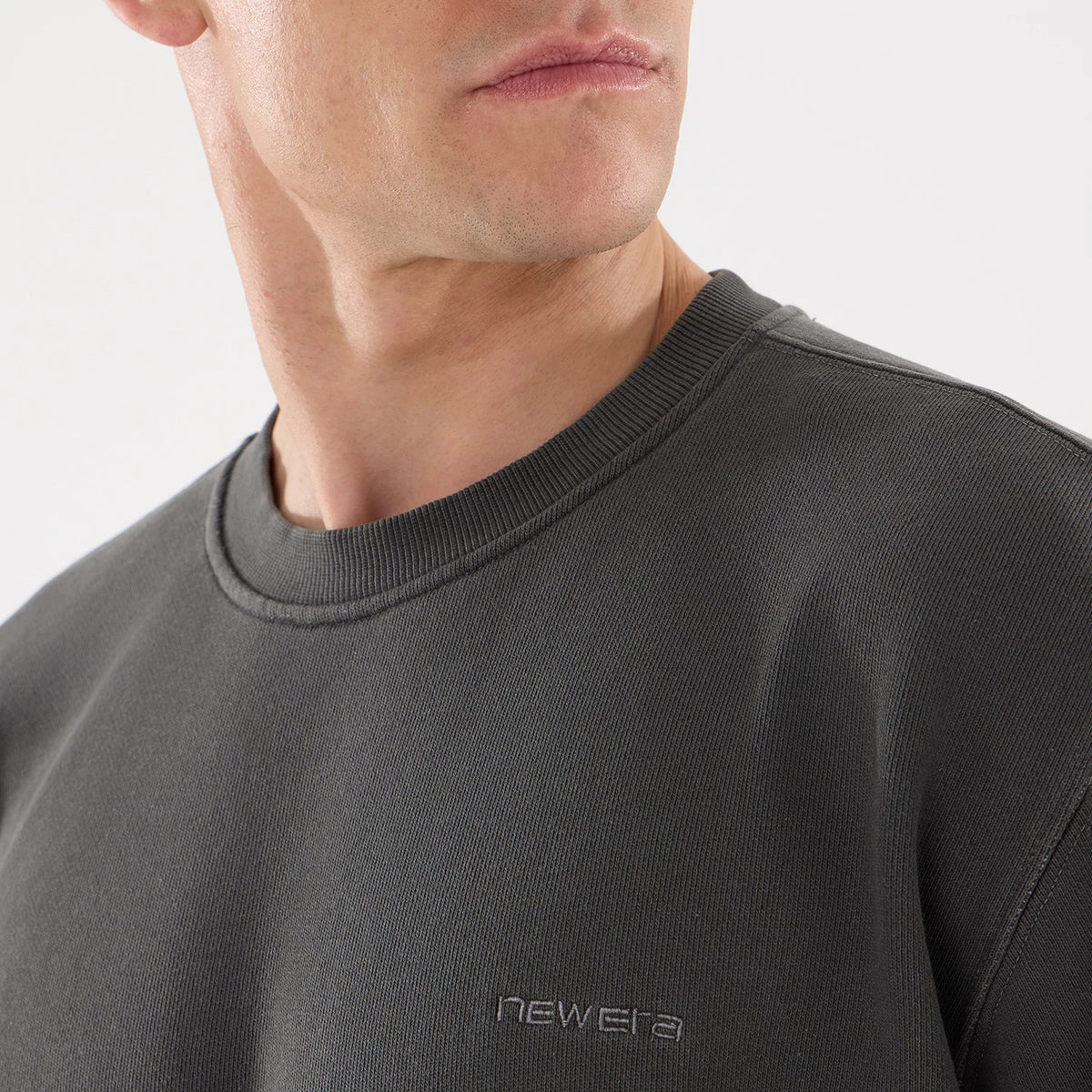 The model is wearing this New Era Originators Crew Neck Sweater in black. 3