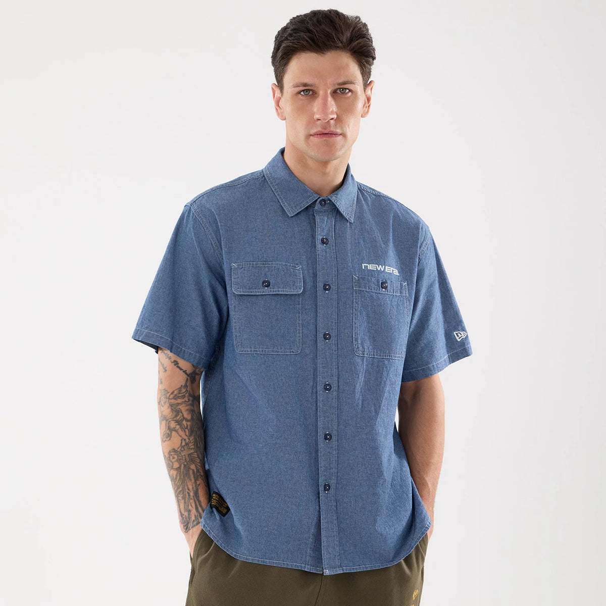 The model is wearing this New Era Originators Chambray Short Sleeve Shirt in dark blue. 1