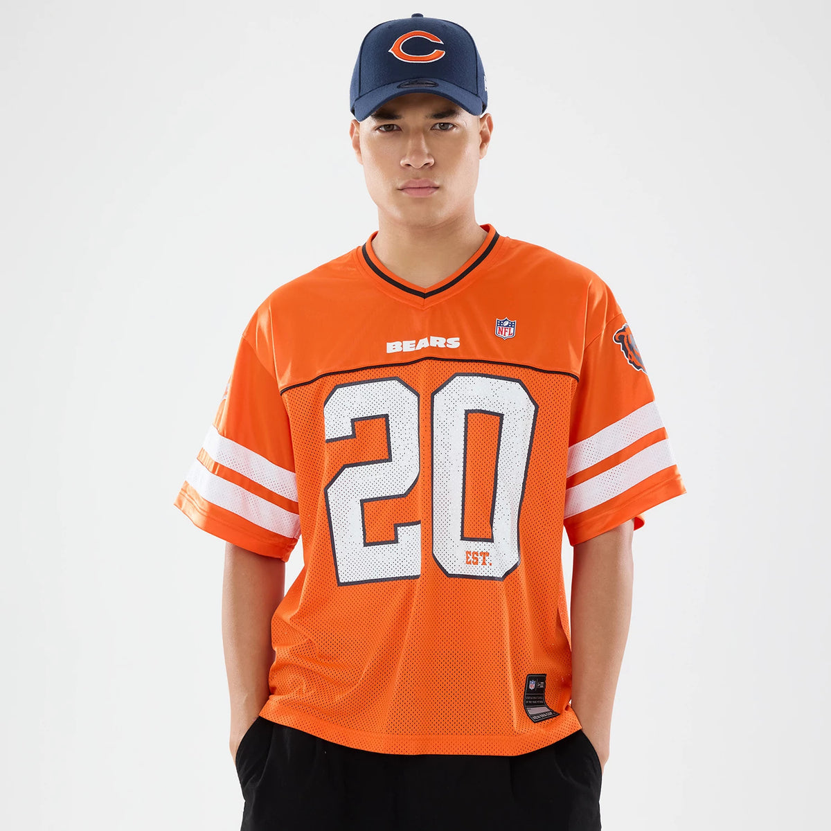 Chicago Bears NFL Orange Mesh Jersey, front view on a model with a dark blue cap, displaying bold white number 20 on the chest with BEARS lettering above, and team logo on the upper sleeve.