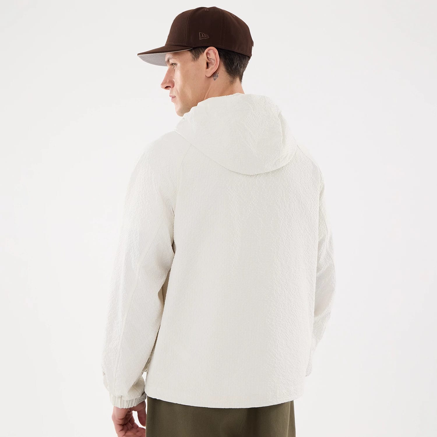 The model is wearing this New Era Black Label Jacket in open white. 2