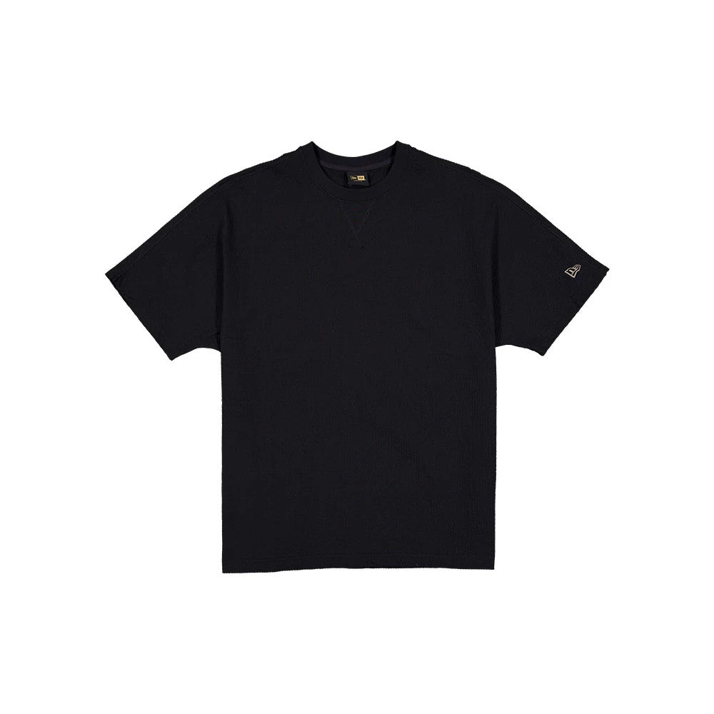The model is wearing this New Era Black Label Seersucker T-Shirt in black. 1