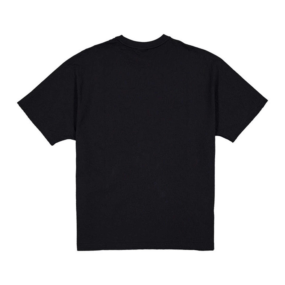 The model is wearing this New Era Black Label Seersucker T-Shirt in black. 2