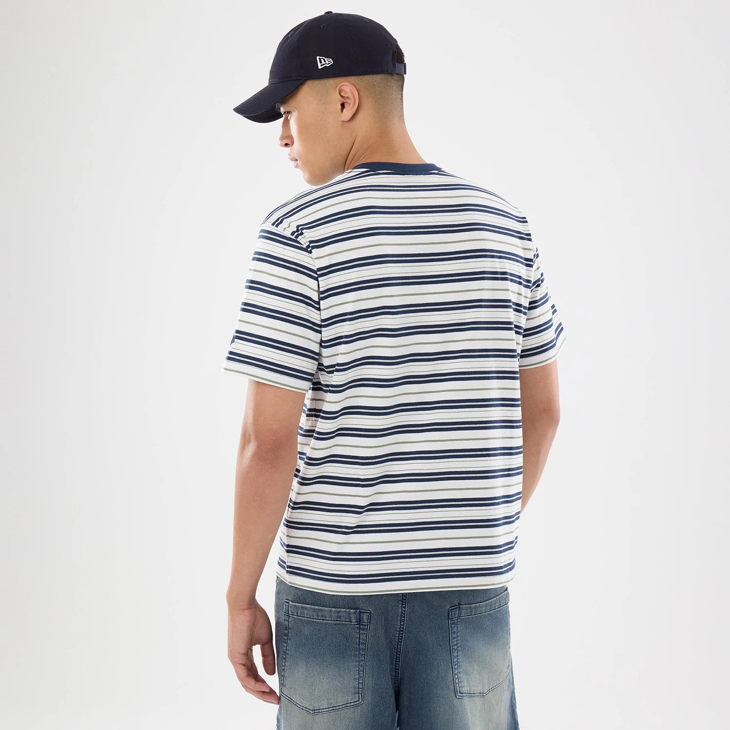 The model is wearing this New Era Boarder Stripe T-Shirt in white. 2