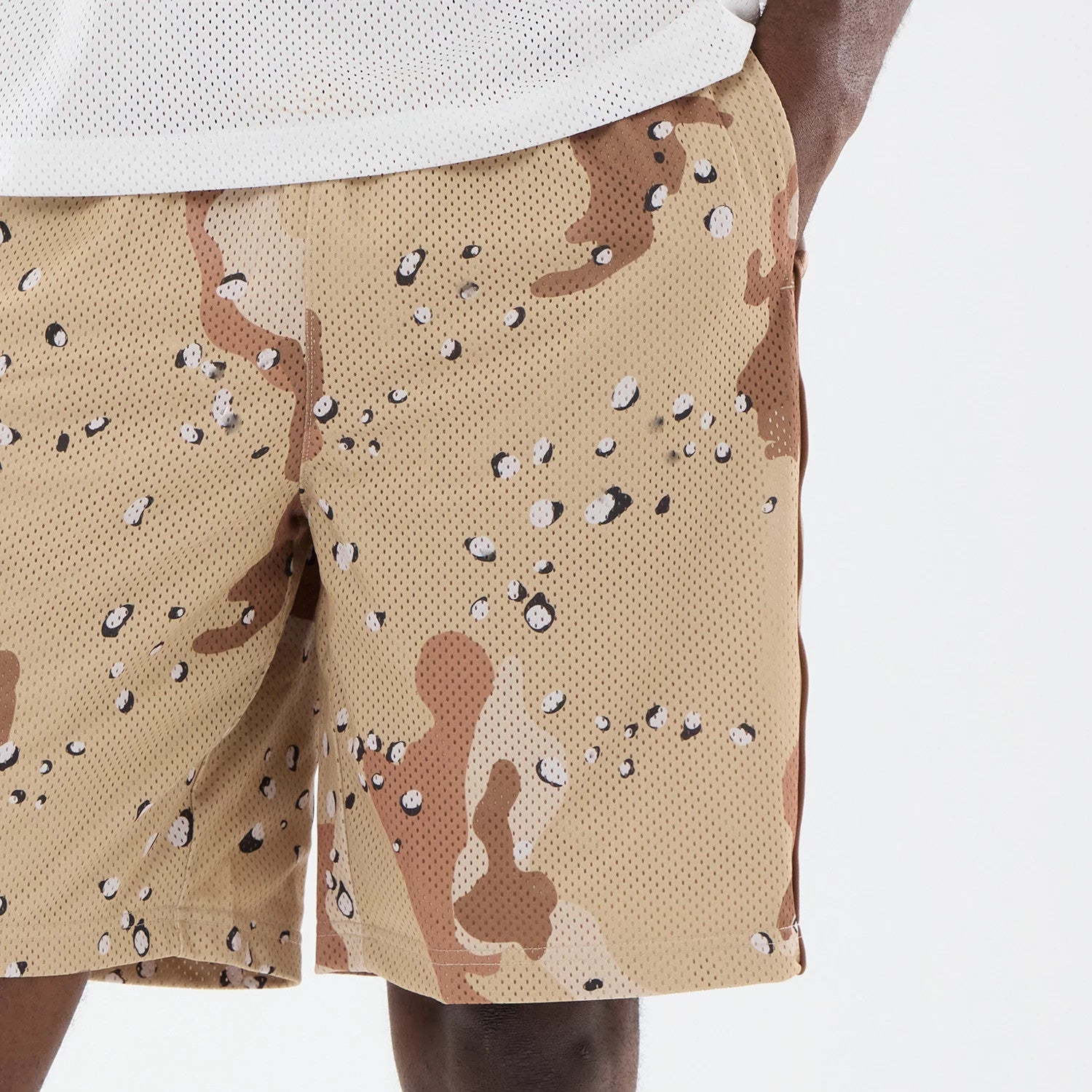 The model is wearing this New Era Bermuda Oversized Shorts in Woodland Camo. 4