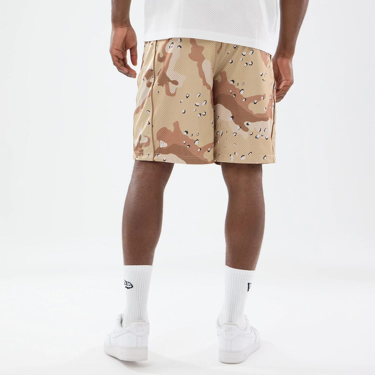 The model is wearing this New Era Bermuda Oversized Shorts in Woodland Camo. 2