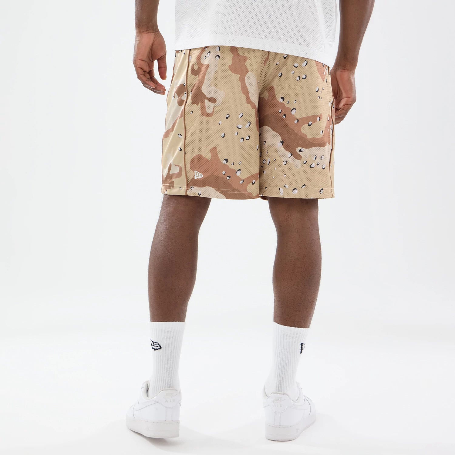 The model is wearing this New Era Bermuda Oversized Shorts in Woodland Camo. 2