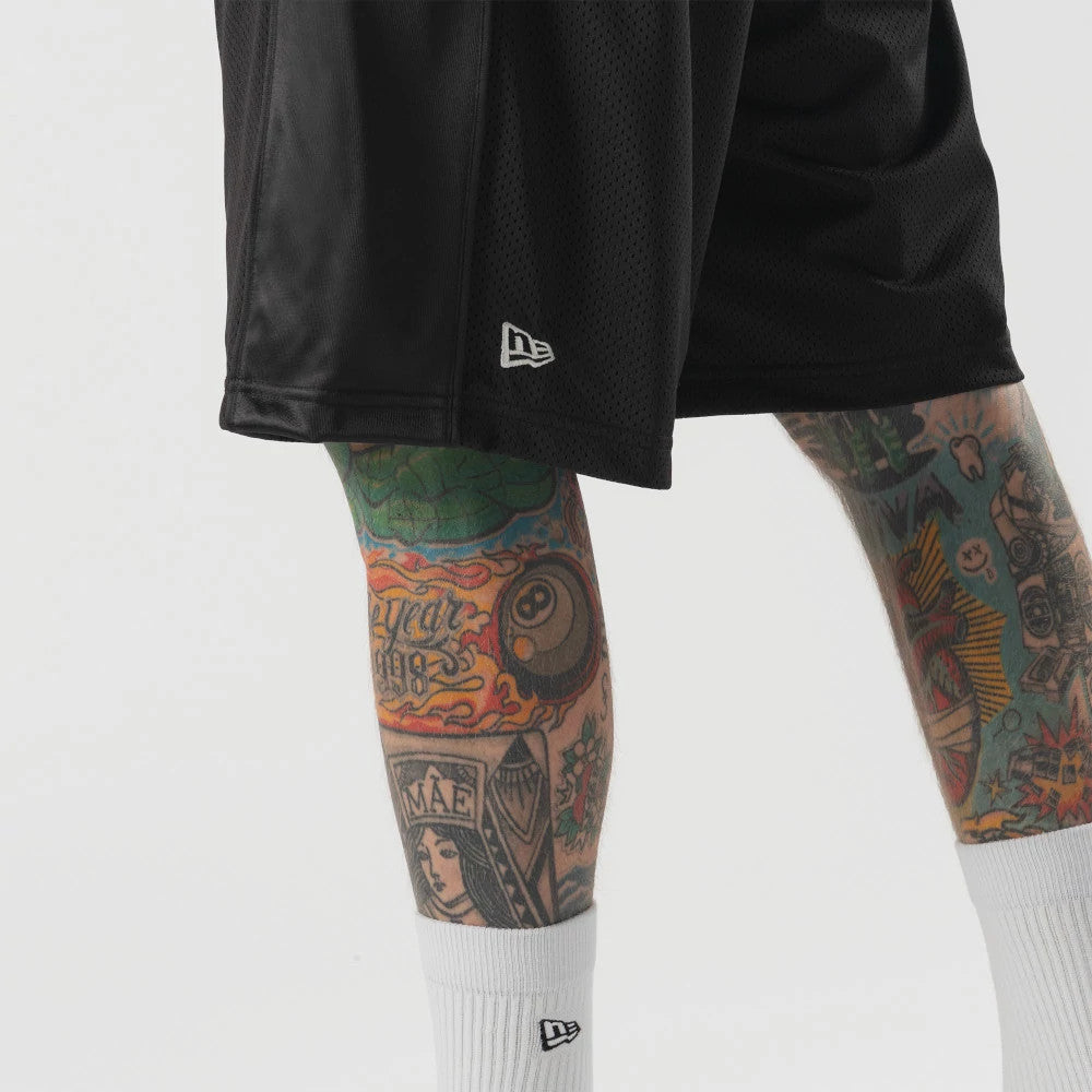 The model is wearing this New Era Bermuda Oversized Shorts in black. 3