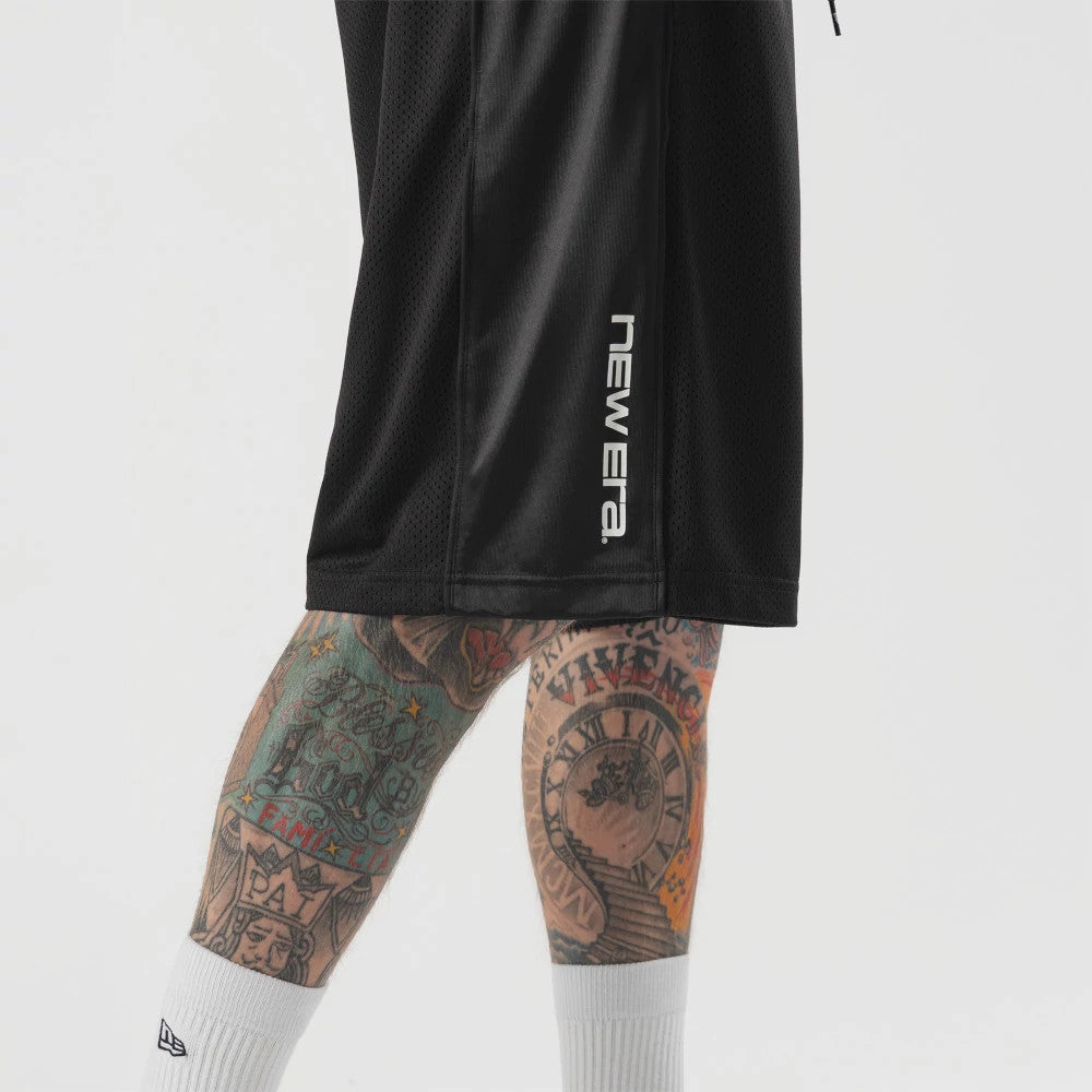 The model is wearing this New Era Bermuda Oversized Shorts in black. 4