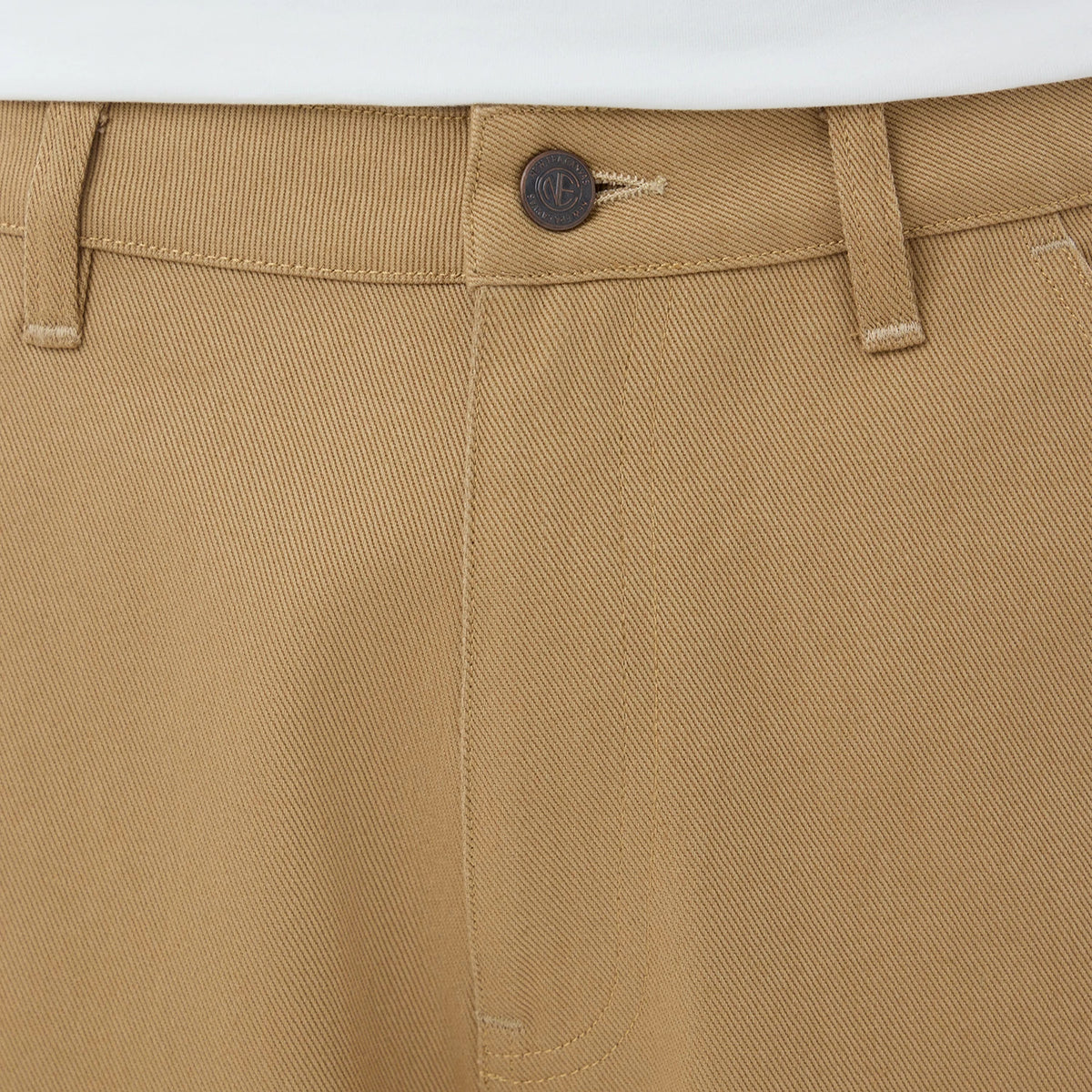 The model is wearing these New Era Work Pants in beige. 5