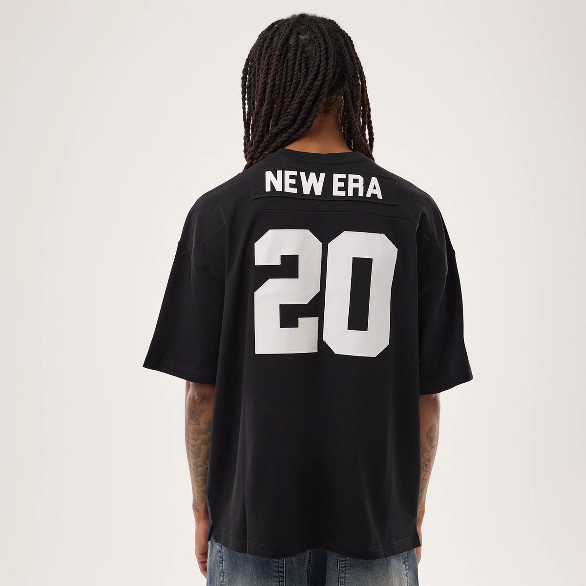 The model is wearing this New Era Fan Family Jersey in black. 2