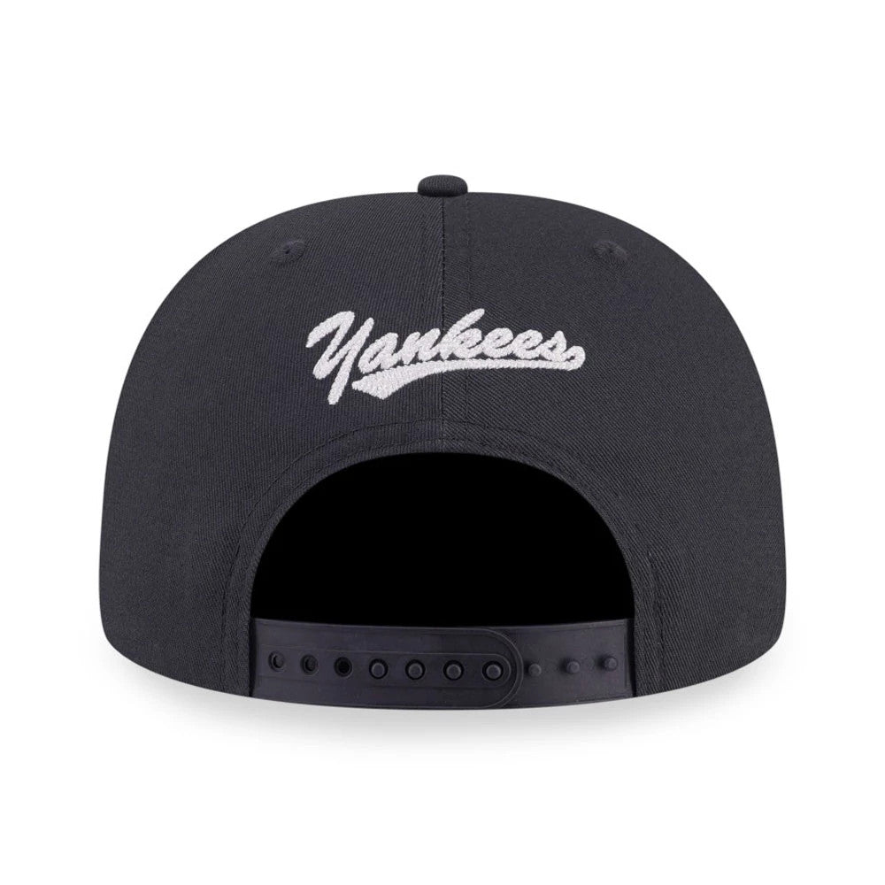 New York Yankees MLB Denim Patchwork Navy New Era 9FIFTY Snapback Adjustable Cap, rear view showing the white embroidered Yankees script logo across the centre back above the adjustable snap closure on the navy crown.