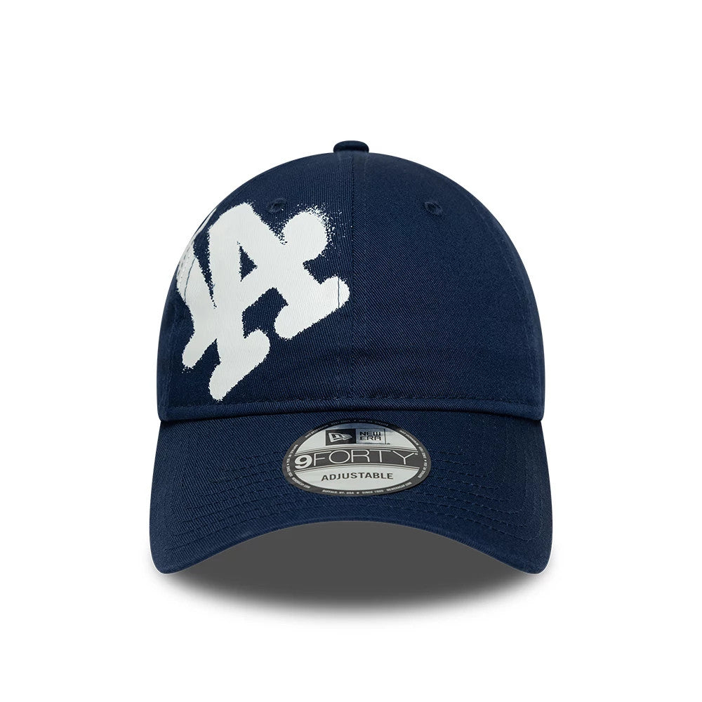 LA Dodgers MLB Spray Paint Dark Blue New Era 9FORTY Adjustable Cap, front view showing the white spray paint effect LA logo in raised embroidery on the front panel with a 9FORTY size sticker on the curved visor.