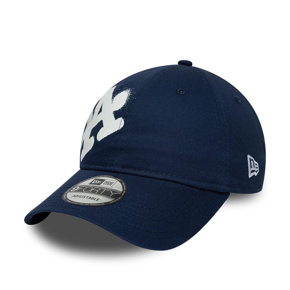 LA Dodgers MLB Spray Paint Dark Blue New Era 9FORTY Adjustable Cap, three-quarter view showing the large white spray paint LA logo on the front panel, with a curved visor and a 9FORTY size sticker, New Era flag logo on the left side.