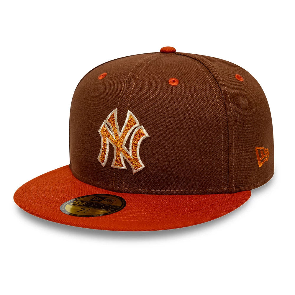New York Yankees MLB Pack Brown New Era 59FIFTY Fitted Cap, three-quarter view showing the raised orange embroidered NY logo on the front panel, orange visor with gold 59FIFTY size sticker, and New Era flag logo on the left side.