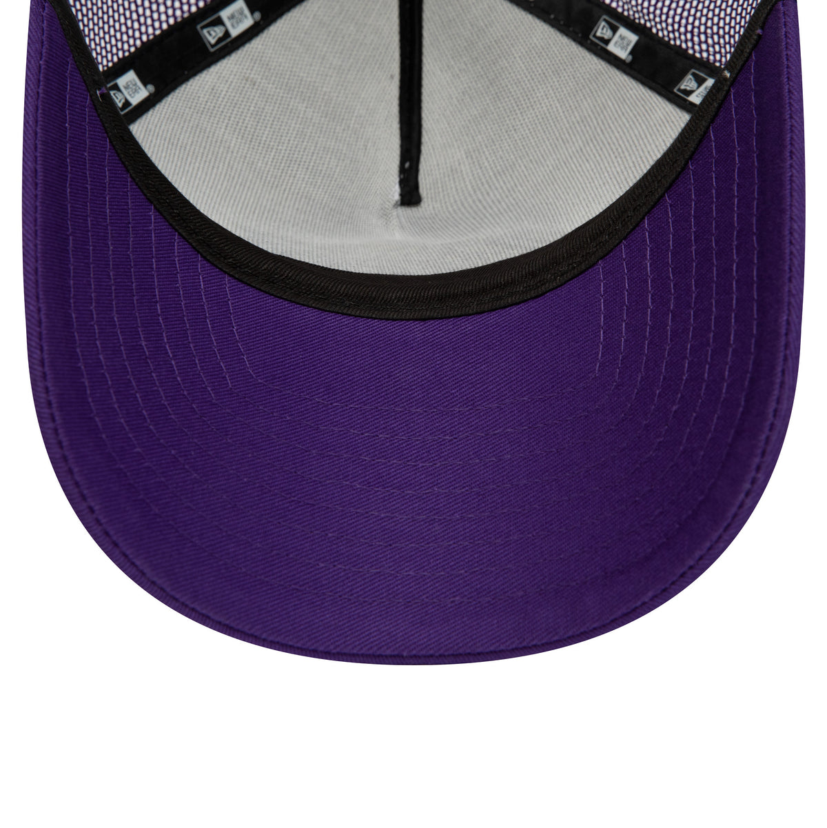 LA Lakers Team Colour Purple A-Frame Trucker Cap, inside view showing the white undervisor, black edge taping with New Era logos, and purple visor, highlighting the mesh back panels for ventilation.