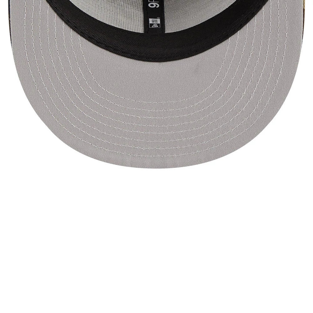 Atlanta Braves MLB Evergreen Camo New Era 9FIFTY Trucker Adjustable Cap, inside view showing black taping with New Era and size details on the grey undervisor and a curved black sweatband.