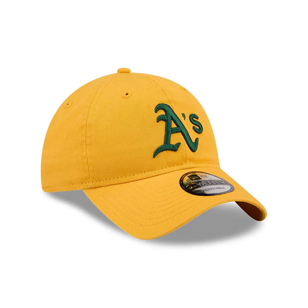 Athletics MLB Evergreen Dark Yellow New Era 9TWENTY Adjustable Cap, three-quarter view showing the green raised embroidered A's logo on the front panel, rounded crown with eyelets, and 9TWENTY size sticker on the curved visor.