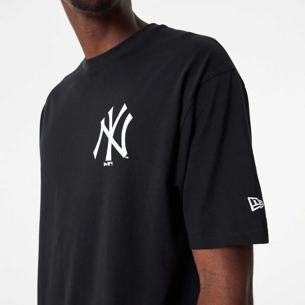 New York Yankees MLB Essential Black Oversized T-Shirt, front view showing the large white NY logo printed on the chest and a small white embroidered New Era logo on the left sleeve near the hem.