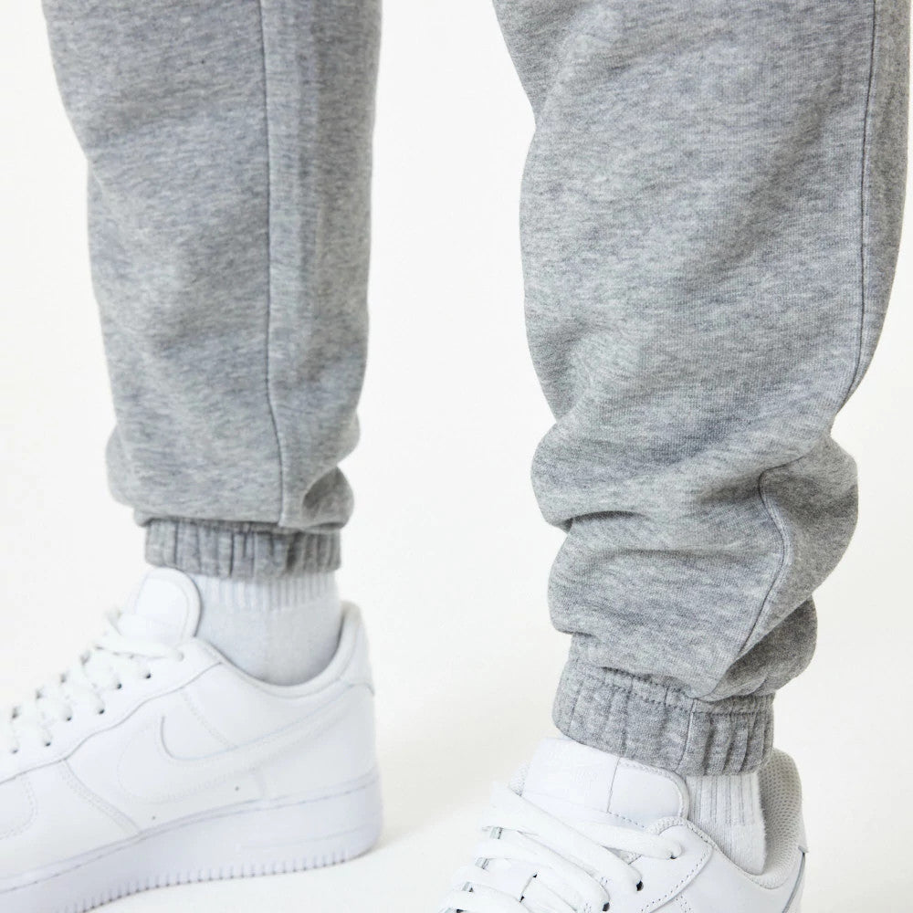 New Era LA Lakers NBA Essential Grey Joggers, close-up view showing the ribbed cuffs on the grey joggers paired with white sneakers, highlighting the soft fabric texture and fit around the ankles.
