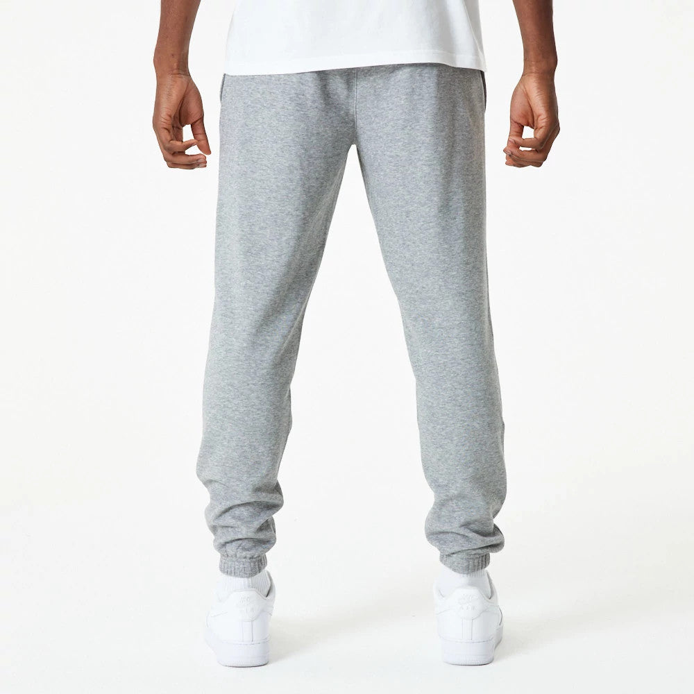 New Era LA Lakers NBA Essential Grey Joggers, back view on a model showing the relaxed fit with elasticated cuffs and waistband, paired with a plain white T-shirt and white trainers for a casual look.