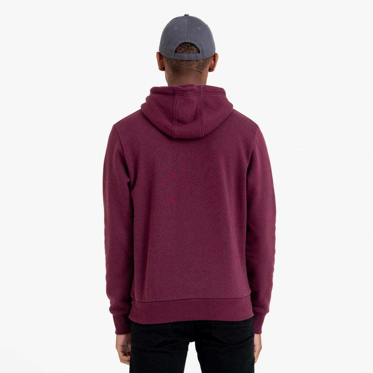 New York Yankees MLB Regular Dark Purple Pullover Hoodie, rear view showing the dark purple fabric with the hood lying flat, worn by a model in a grey cap with eyelets on the back.