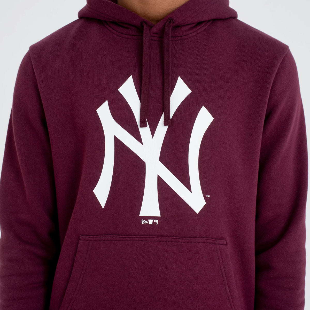 New York Yankees MLB Regular Dark Purple Pullover Hoodie, front view showing a large white Yankees logo printed on the chest, the drawstrings hanging from the hood, and a spacious kangaroo pocket below the logo.