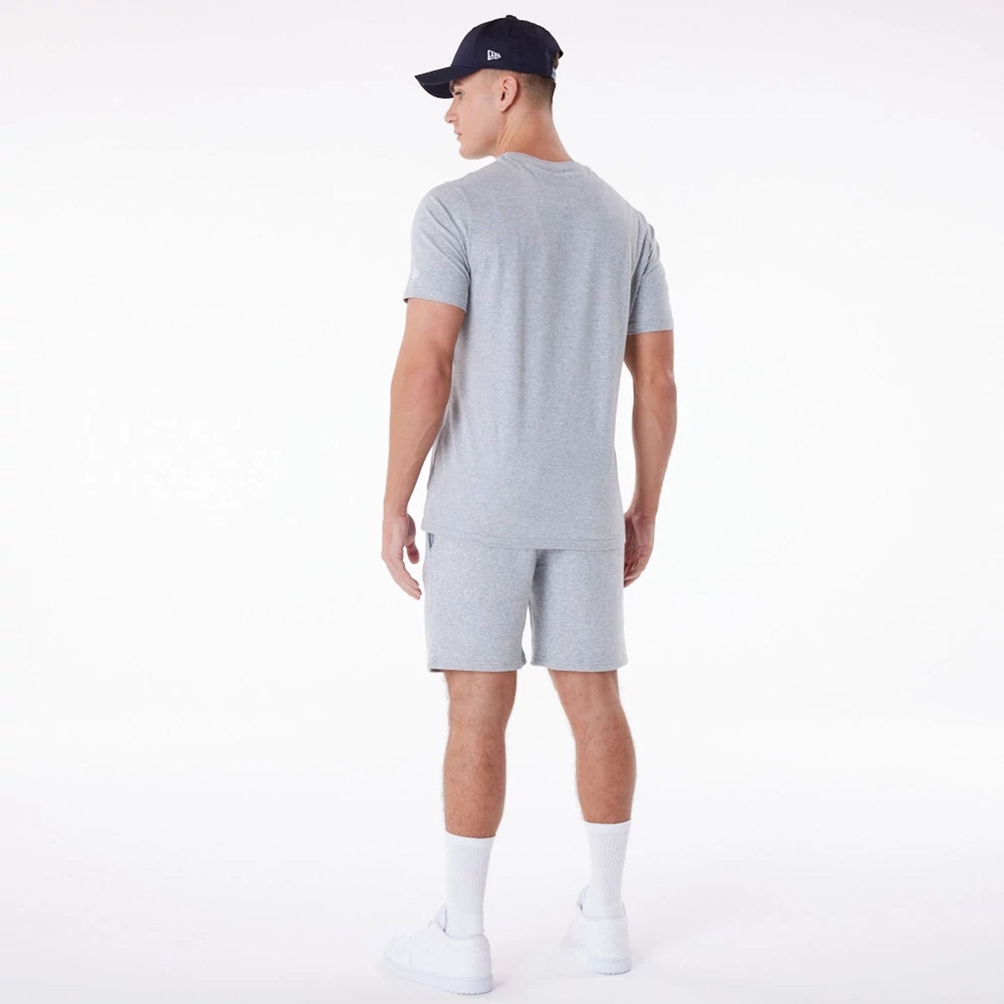 The Male model is wearing New Era Essential Grey Shorts 9