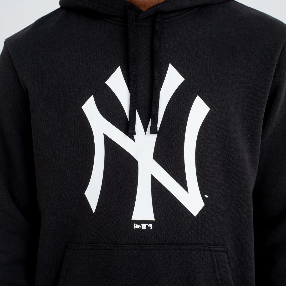 New York Yankees MLB Regular Black Pullover Hoodie, front view showing a bold white Yankees logo centred on the chest, with a small embroidered logo beneath it and the drawstrings hanging from the hood.