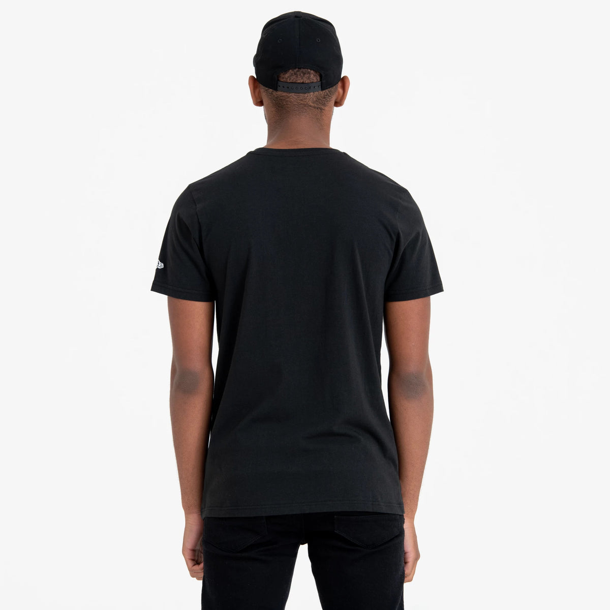 New York Yankees MLB Regular Black T-Shirt, rear view showing the black fabric with a short-sleeve design, an embroidered white New Era logo on the left sleeve, and the back of a black cap with eyelets on the head.