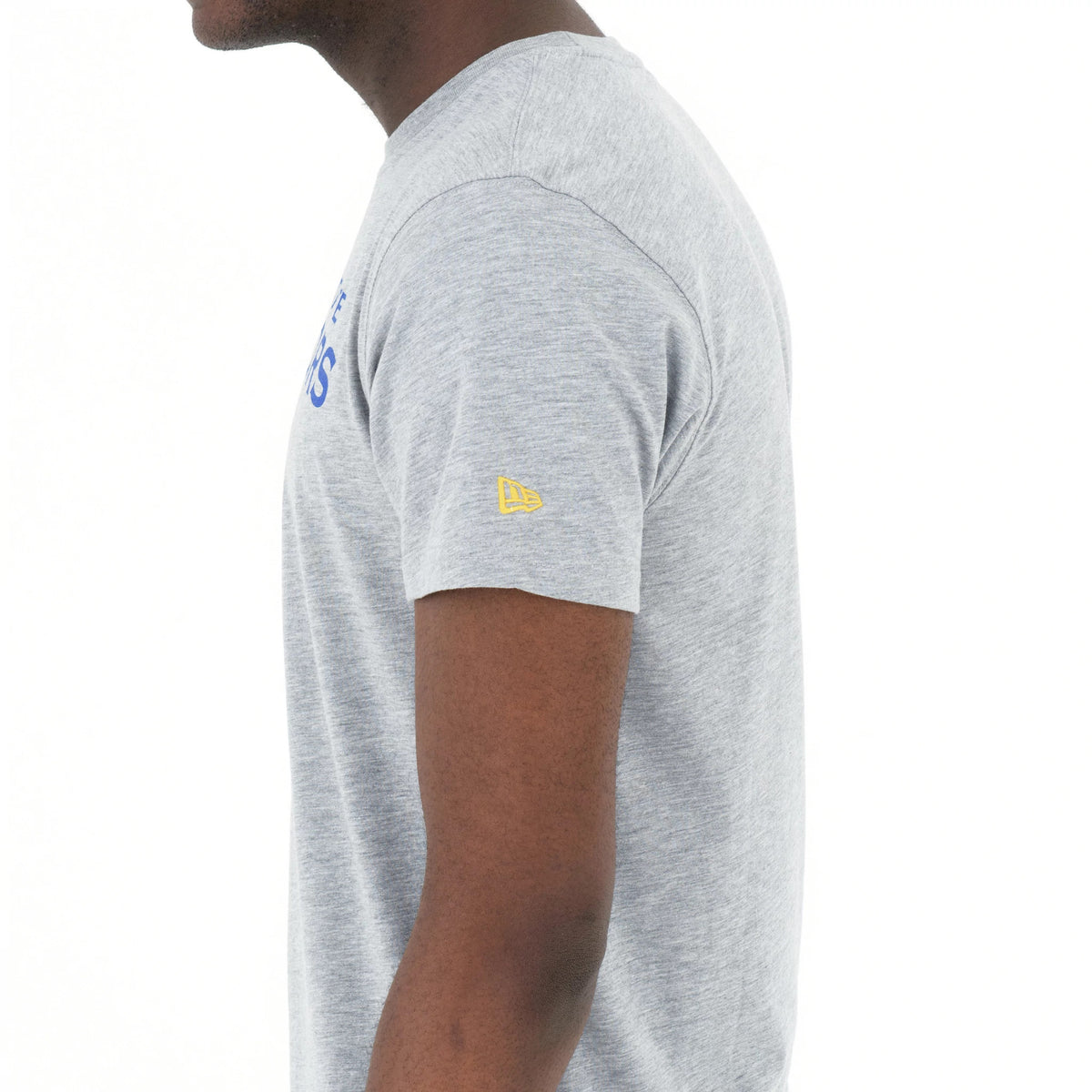 Golden State Warriors NBA Regular Grey T-Shirt, side view showing the soft grey fabric with a yellow embroidered New Era logo on the upper sleeve and partial bold blue text across the chest.
