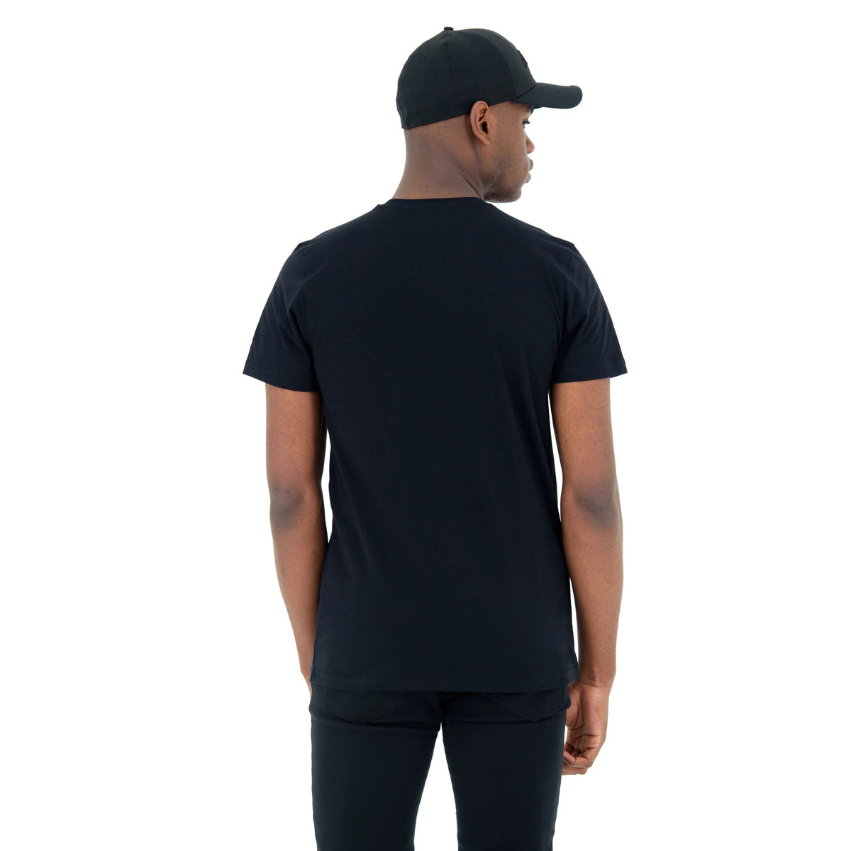 LA Lakers NBA Regular Black T-Shirt, on-model rear view showing the plain black T-shirt with a straight hem and short sleeves, worn with a black cap featuring an embossed logo on the front.