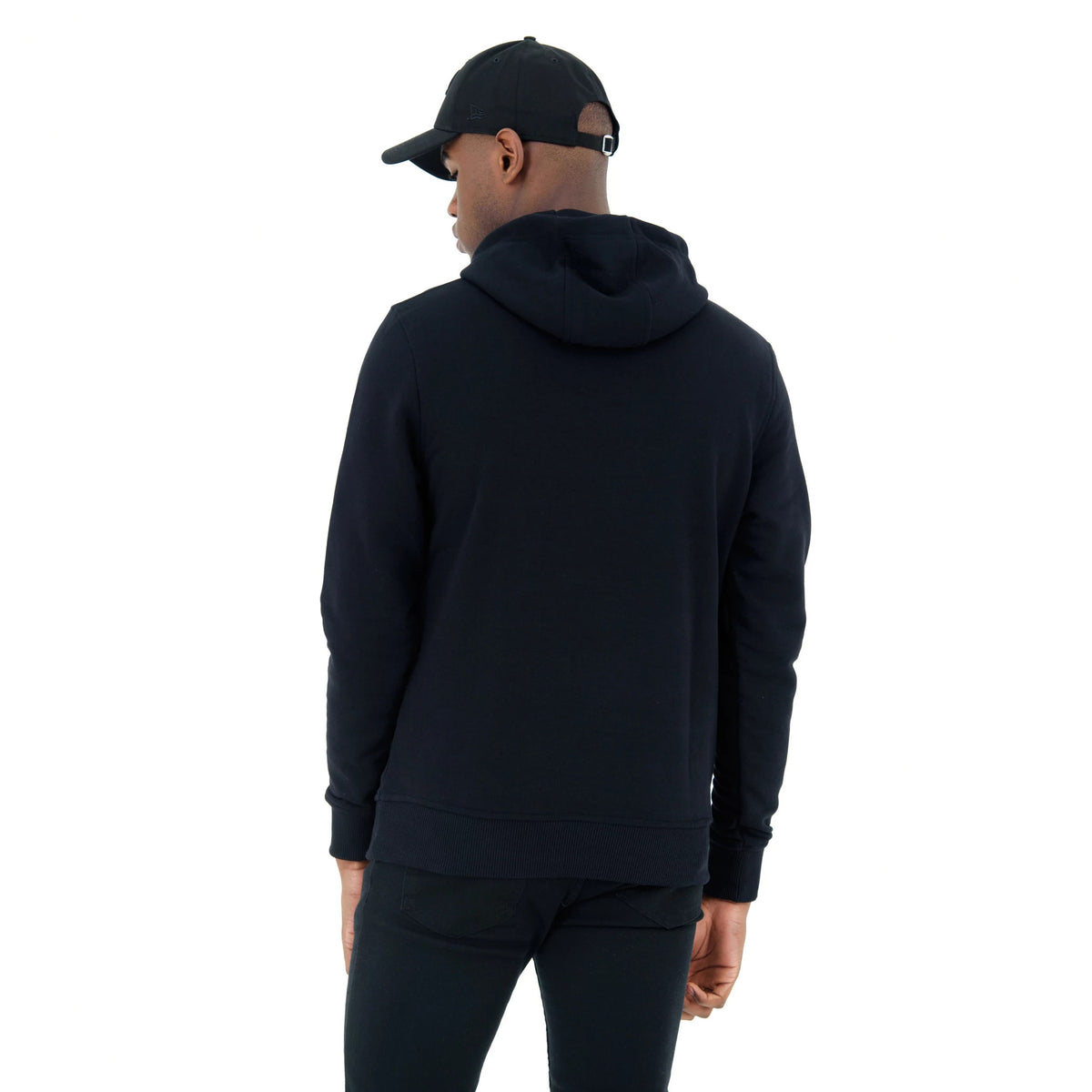 Chicago Bulls NBA Regular Black Pullover Hoodie, rear view showing the plain black fabric with a relaxed fit, the hood laying flat against the back and ribbed cuffs at the wrists and hem, worn by a model also wearing a black cap.