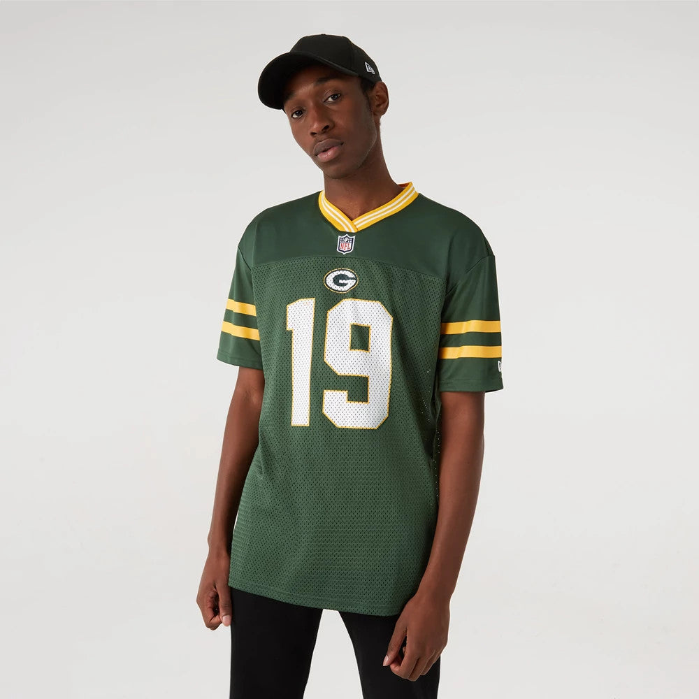 New Era Green Bay Packers NFL Dark Green Mesh T-Shirt, on-model view featuring a dark green mesh body with yellow stripes on the sleeves, the number 19 in white mesh on the front, and the Packers logo centred on the chest.