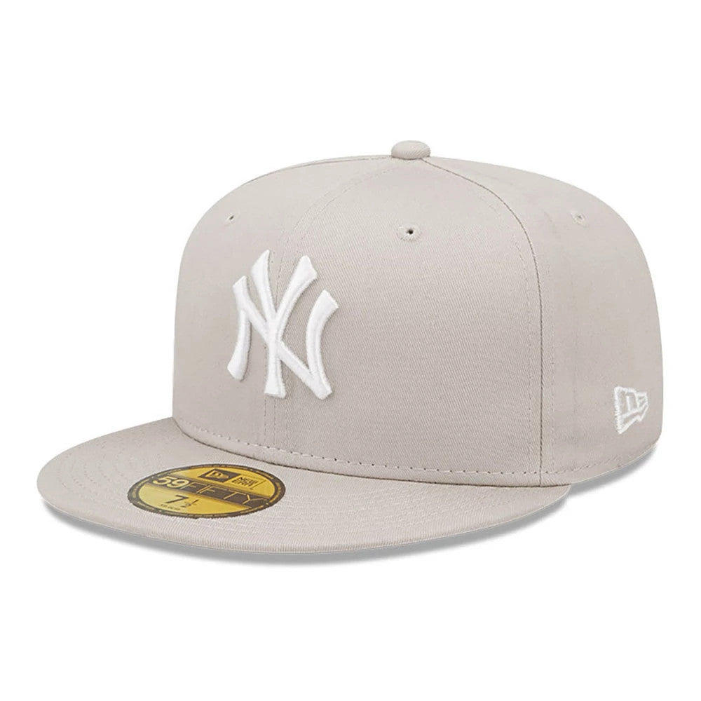 New York Yankees League Essential Stone New Era 59FIFTY Fitted Cap, front view showing the white embroidered NY logo on the front panel, stone-coloured visor with gold 59FIFTY size sticker and New Era flag logo on the left side.