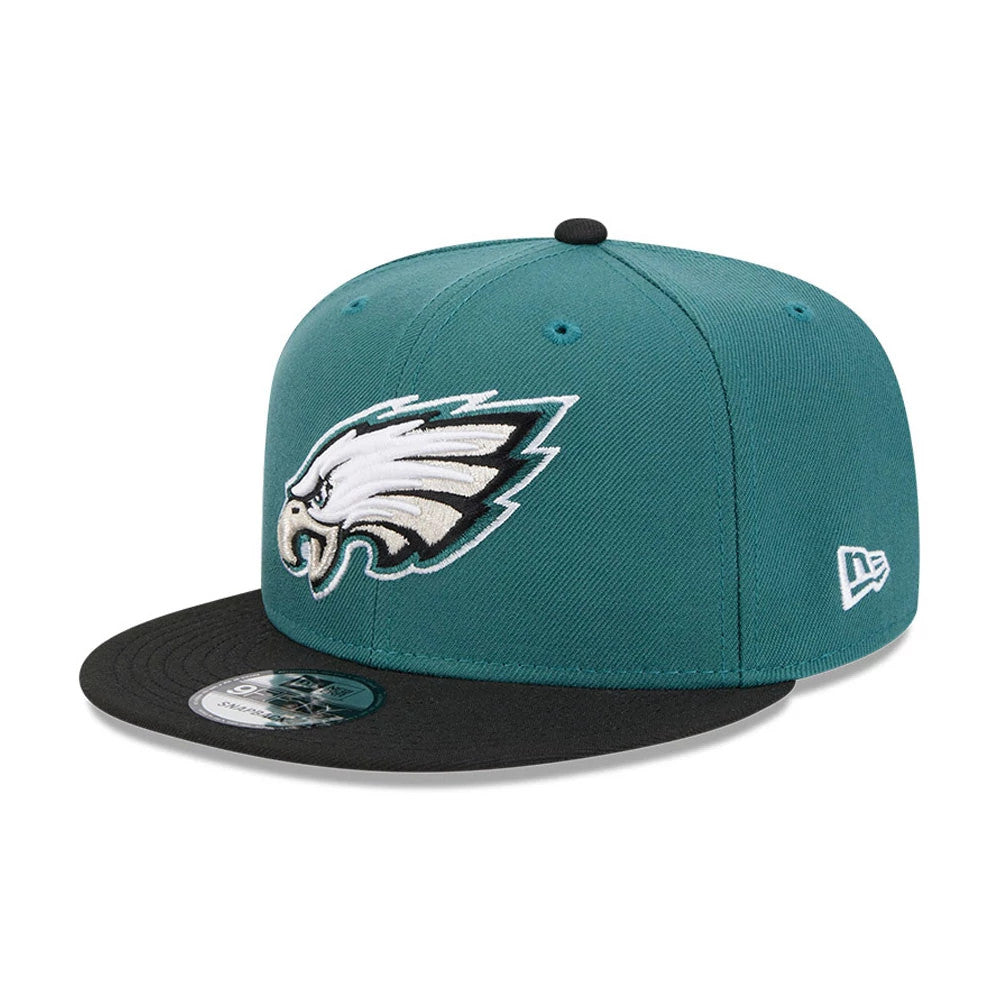 Eagles NFL Evergreen Dark Green New Era 9FIFTY Snapback Adjustable Cap, three-quarter view showing the raised embroidered Eagles logo on the front panel, a black visor with a 9FIFTY size sticker, and the New Era flag logo on the left side.