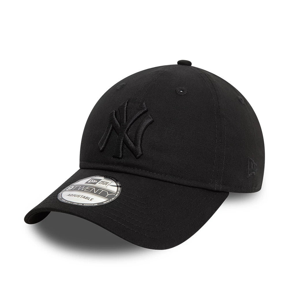 New York Yankees League Essential Black On Black New Era 9TWENTY Adjustable Cap, three-quarter view showing the raised black NY logo on the front panel, curved visor with 9TWENTY size sticker, and New Era flag logo on the left side.