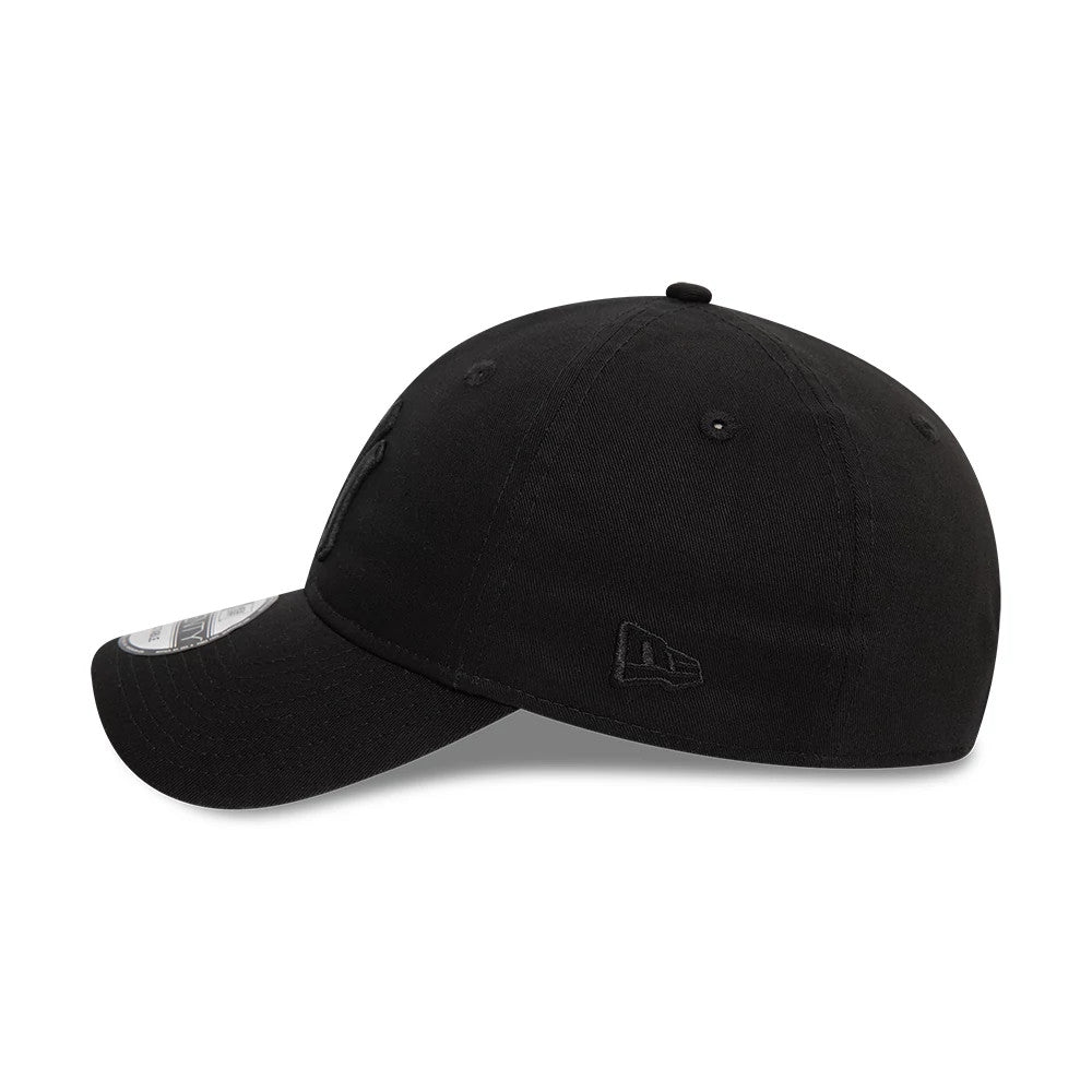 New York Yankees League Essential Black On Black New Era 9TWENTY Adjustable Cap, side view showing the black embroidered New Era flag logo on the left side and the gently curved visor with a 9TWENTY size sticker.